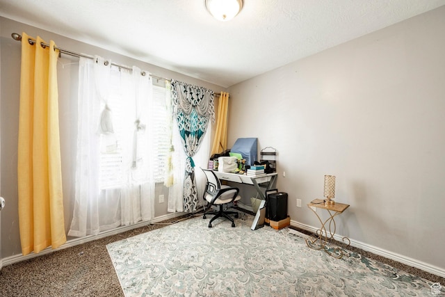 carpeted office space featuring baseboards
