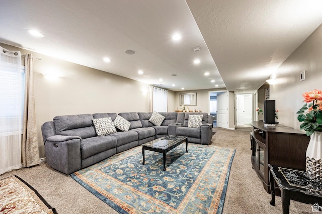 living area featuring light colored carpet and recessed lighting