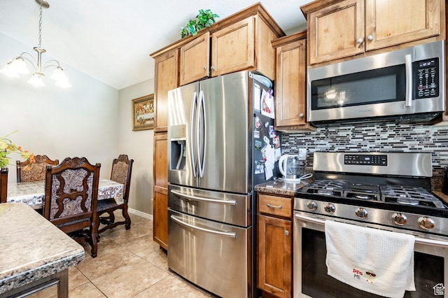 kitchen with stainless steel appliances, a chandelier, decorative backsplash, vaulted ceiling, and light tile patterned floors