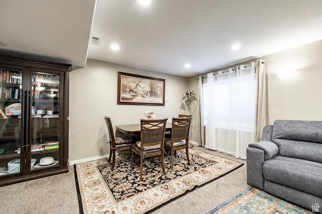 carpeted dining space with recessed lighting and baseboards