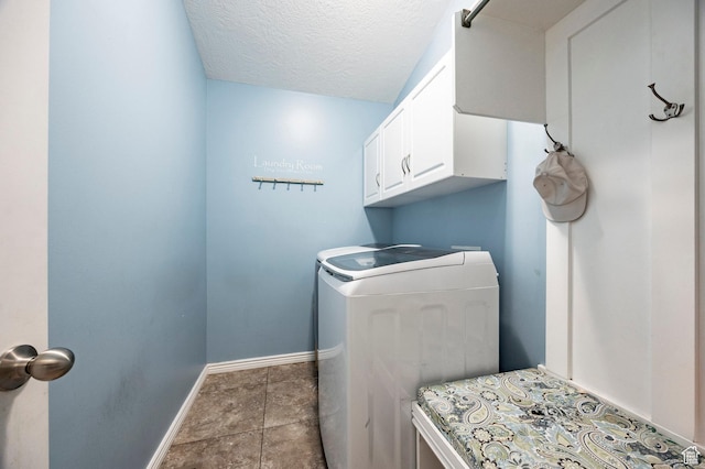 laundry room with cabinet space, washer and dryer, baseboards, and a textured ceiling