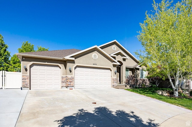 view of front of property featuring stucco siding, a garage, stone siding, concrete driveway, and fence