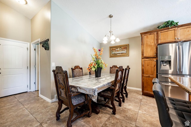 dining space with lofted ceiling, a chandelier, light tile patterned flooring, and baseboards