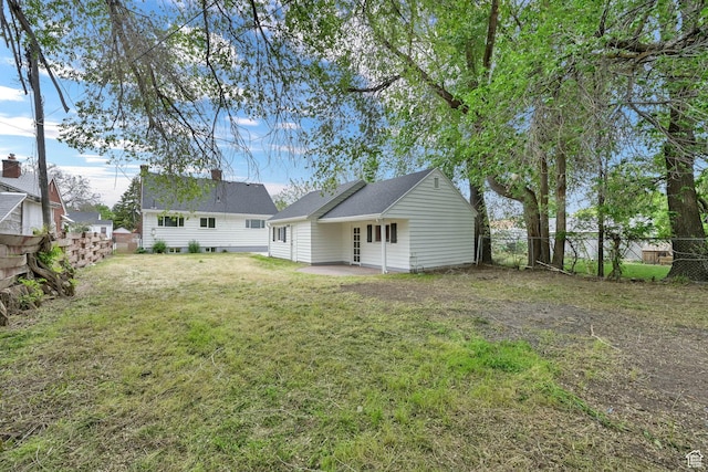 back of house featuring a patio area and a chimney