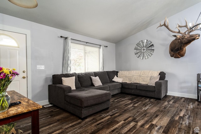 living area featuring vaulted ceiling, dark wood finished floors, and baseboards
