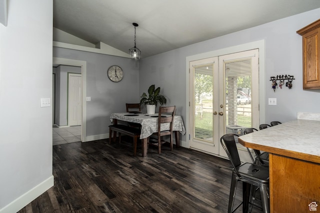 dining area featuring french doors, dark wood finished floors, baseboards, and lofted ceiling
