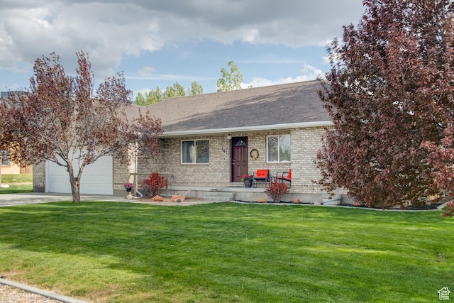 ranch-style home featuring brick siding, a garage, concrete driveway, and a front lawn