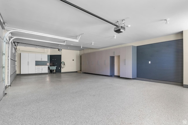 81 E Lone Hollow Dr S, Sandy, UT 84092 - garage with a garage door opener, a sink, and baseboards