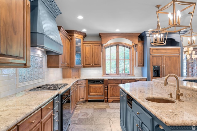 81 E Lone Hollow Dr S, Sandy, UT 84092 - kitchen with custom range hood, stainless steel gas cooktop, oven, a chandelier, and a sink