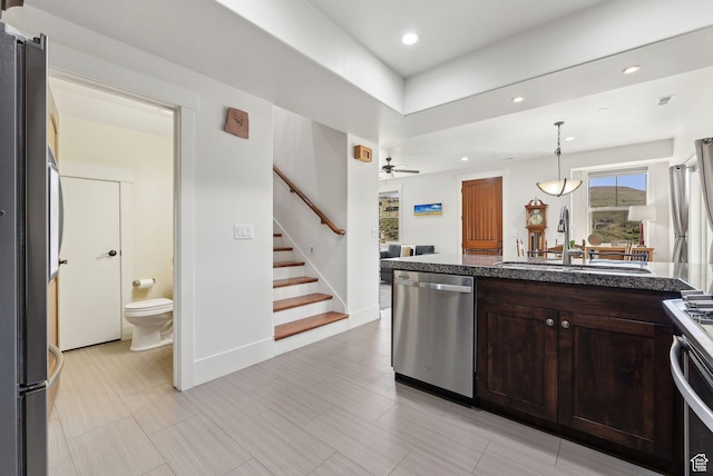 13312 N Highmark Ct, Kamas, UT 84036 - kitchen with stainless steel dishwasher, a sink, dark brown cabinets, ceiling fan, and decorative light fixtures