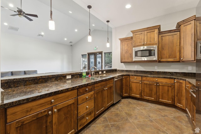 13312 N Highmark Ct, Kamas, UT 84036 - kitchen with appliances with stainless steel finishes, a sink, dark tile patterned floors, decorative light fixtures, and a ceiling fan