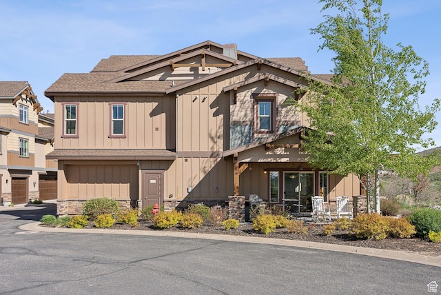 13312 N Highmark Ct, Kamas, UT 84036 - view of front facade featuring stone siding, roof with shingles, board and batten siding, and an attached garage