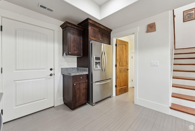 13312 N Highmark Ct, Kamas, UT 84036 - kitchen with stainless steel refrigerator with ice dispenser, dark brown cabinetry, and light stone counters