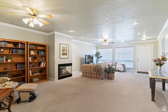 269 River Cove Dr, Morgan, UT 84050 - living area with ceiling fan, a tile fireplace, carpet flooring, a textured ceiling, and ornamental molding