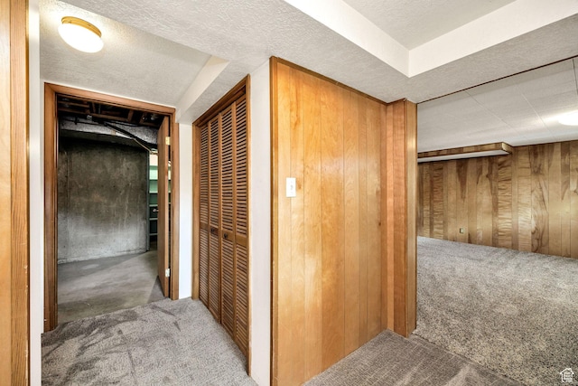 corridor with carpet floors and wooden walls