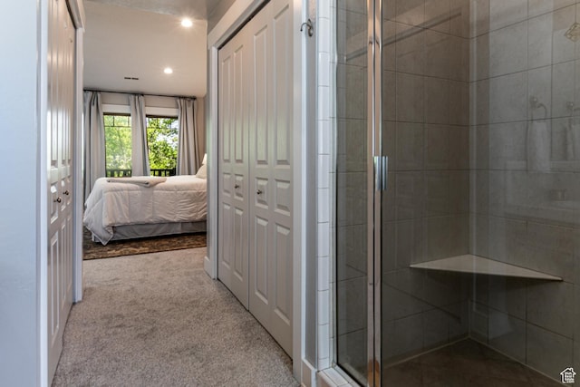ensuite bathroom featuring a stall shower and recessed lighting