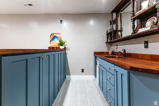 indoor wet bar with baseboards and light colored carpet