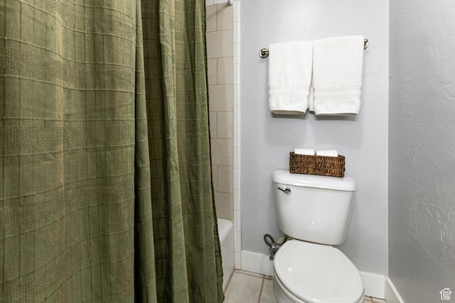 bathroom featuring baseboards, toilet, and tile patterned floors