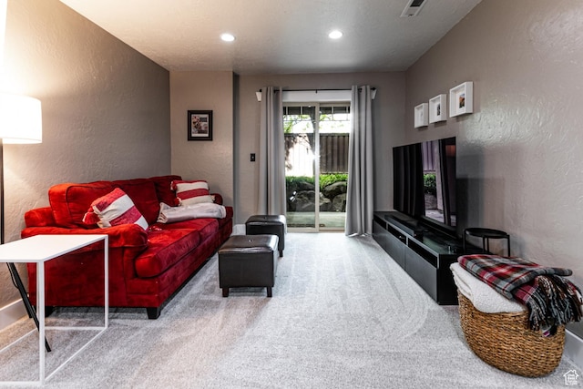 living room with a textured wall, carpet flooring, and recessed lighting