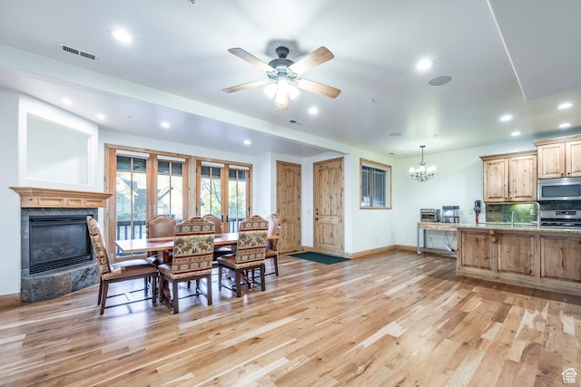 3033 Canyon Links Dr, Park City, UT 84098 - dining space with a chandelier, light wood-style floors, a high end fireplace, baseboards, and recessed lighting