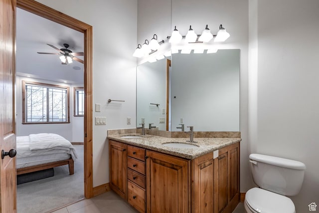 3033 Canyon Links Dr, Park City, UT 84098 - ensuite bathroom featuring double vanity, toilet, a ceiling fan, tile patterned floors, and baseboards