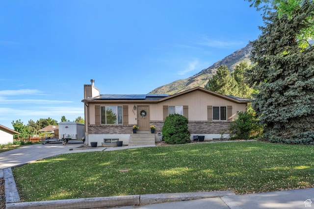 255 E 1230 N, Springville, UT 84663 - ranch-style home featuring brick siding, solar panels, a front yard, a mountain view, and a chimney