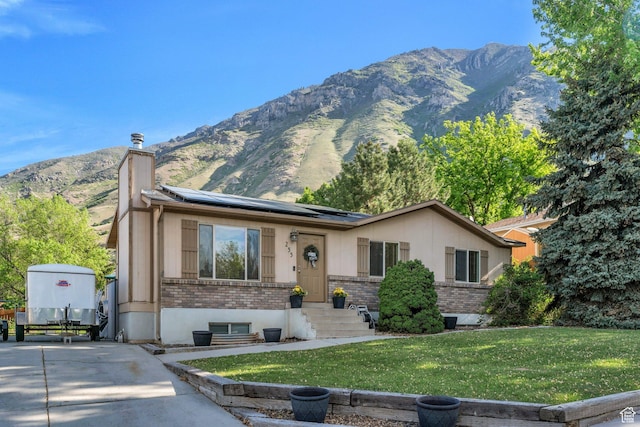 255 E 1230 N, Springville, UT 84663 - ranch-style house featuring brick siding, a front lawn, a chimney, and solar panels
