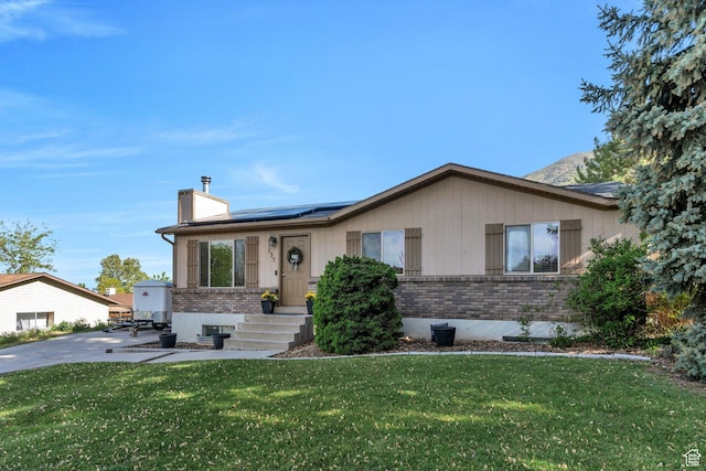 255 E 1230 N, Springville, UT 84663 - ranch-style home featuring brick siding, solar panels, a chimney, and a front lawn