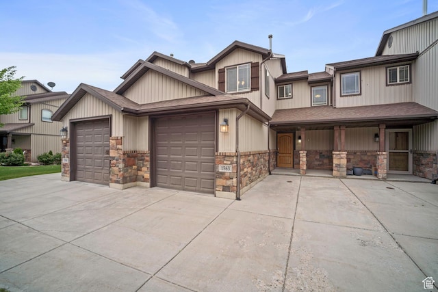 1563 N 450 E, North Ogden, UT 84404 - view of front of home featuring driveway, an attached garage, stone siding, and a shingled roof