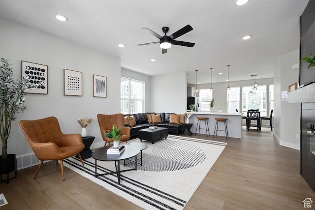 3478 S Wick Ct Unit 61, South Salt Lake, UT 84115 - living room with light wood finished floors, baseboards, a ceiling fan, recessed lighting, and a glass covered fireplace
