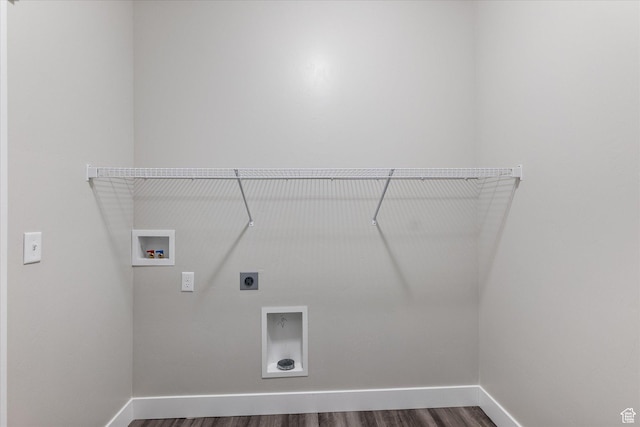 laundry area with electric dryer hookup, dark wood-style flooring, hookup for a washing machine, and baseboards