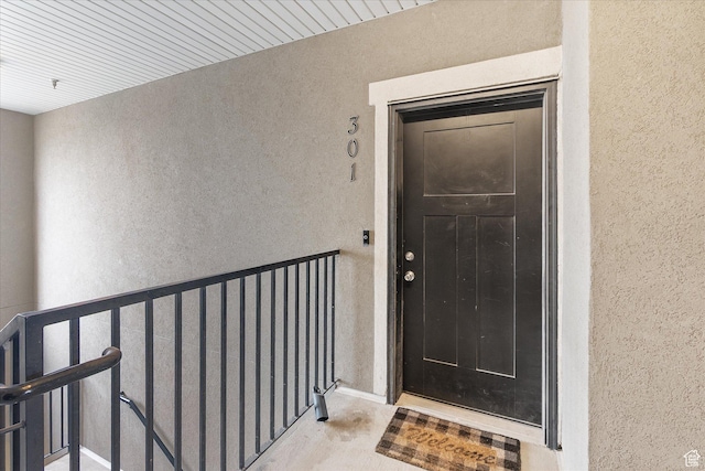doorway to property with stucco siding and a balcony