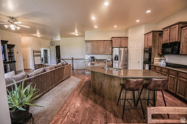 2817 S 1415 W, Syracuse, UT 84075 - kitchen featuring black appliances, a sink, an island with sink, open floor plan, and dark wood-type flooring