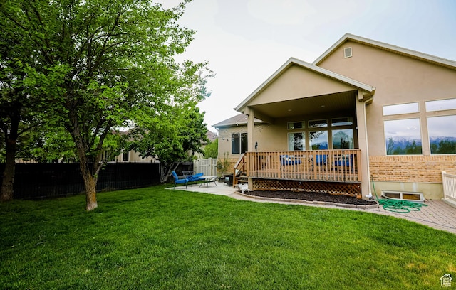 2817 S 1415 W, Syracuse, UT 84075 - rear view of house with stucco siding, a patio area, and a wooden deck