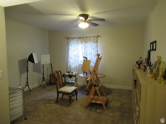 living area with ceiling fan, carpet flooring, and baseboards