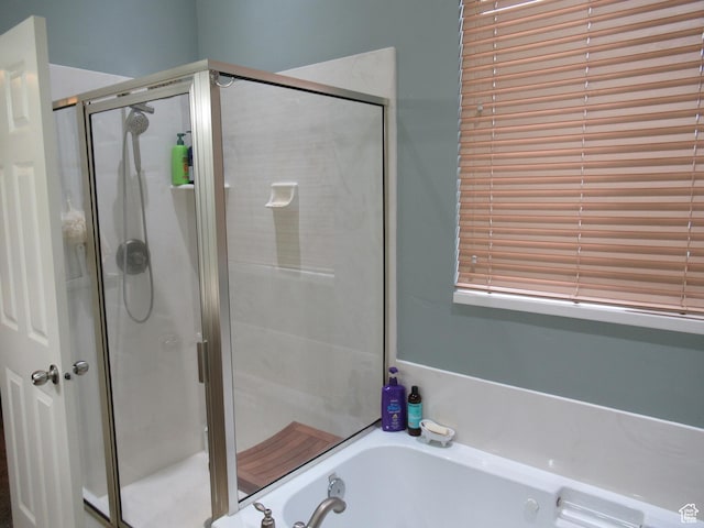 bathroom featuring a garden tub and a stall shower