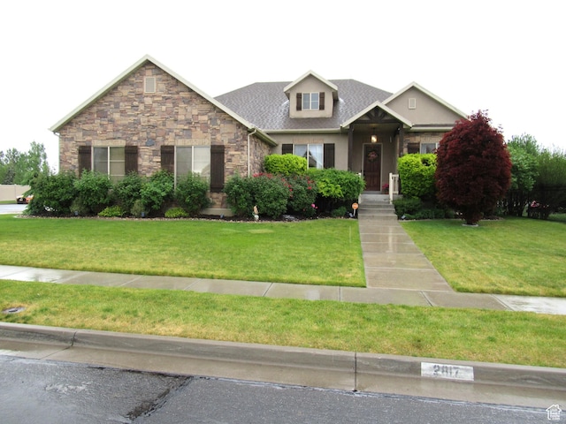 view of front of property featuring stone siding and a front lawn