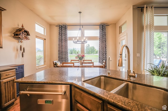 2817 S 1415 W, Syracuse, UT 84075 - kitchen with stainless steel dishwasher, a chandelier, a sink, hanging light fixtures, and dark stone countertops