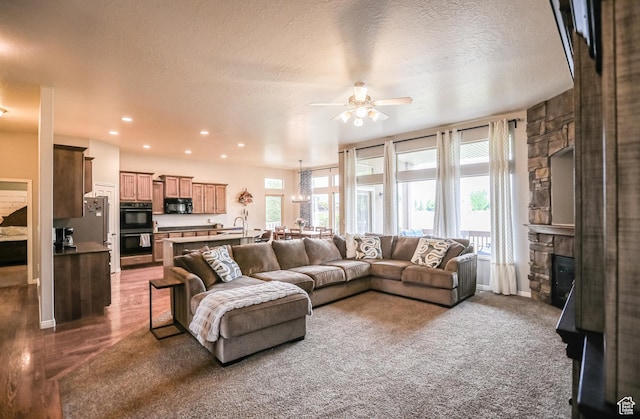 2817 S 1415 W, Syracuse, UT 84075 - living area featuring ceiling fan, a stone fireplace, recessed lighting, and a textured ceiling