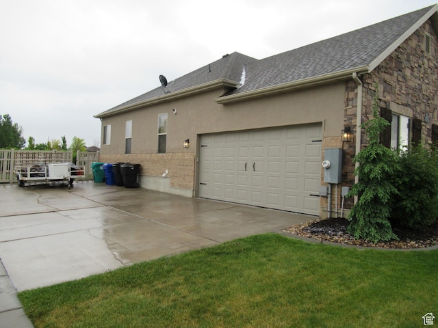 view of side of home with concrete driveway, stone siding, stucco siding, and a garage