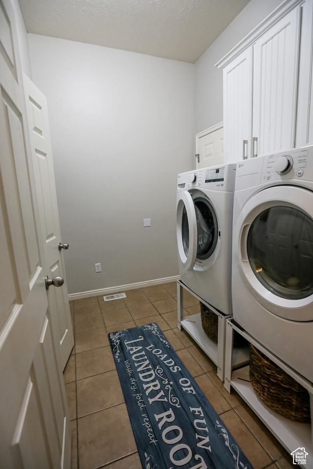 2817 S 1415 W, Syracuse, UT 84075 - laundry area featuring independent washer and dryer, tile patterned flooring, cabinet space, and baseboards