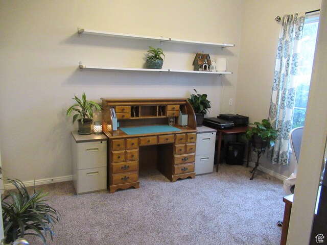 carpeted home office featuring baseboards