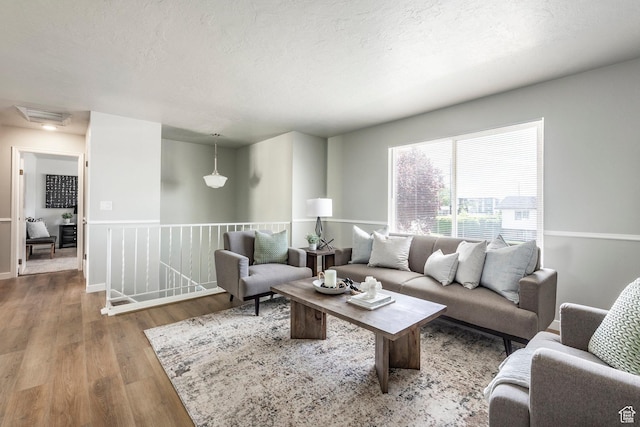 living area with wood finished floors and a textured ceiling