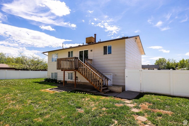 back of property with stairs, a gate, a deck, and a patio area