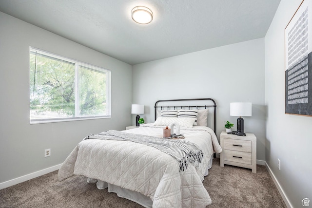 bedroom with carpet and baseboards