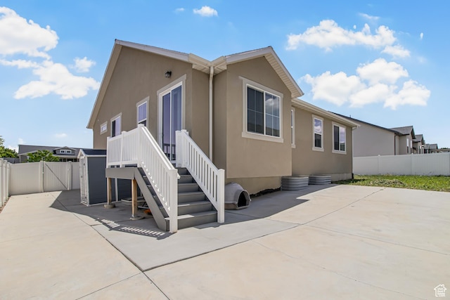 2994 S Tangent Peak Rd, Magna, UT 84044 - back of property featuring a patio, a fenced backyard, and stucco siding