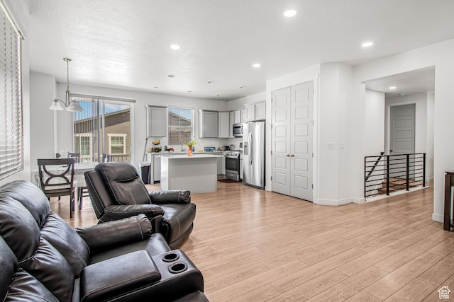 2994 S Tangent Peak Rd, Magna, UT 84044 - living room featuring light wood-style floors, recessed lighting, and baseboards