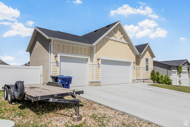 2994 S Tangent Peak Rd, Magna, UT 84044 - view of home's exterior with board and batten siding, a garage, and driveway
