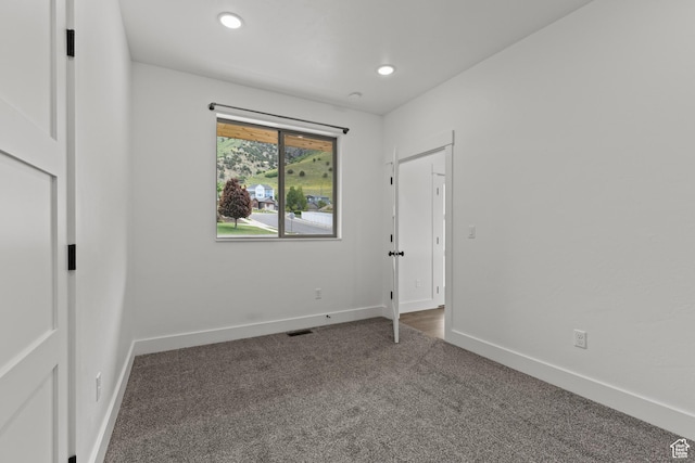 1885 N 2000 E, North Logan, UT 84341 - unfurnished room featuring dark carpet, baseboards, and recessed lighting