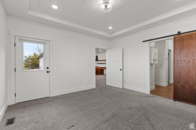 1885 N 2000 E, North Logan, UT 84341 - unfurnished bedroom featuring a tray ceiling, carpet flooring, recessed lighting, baseboards, and a barn door